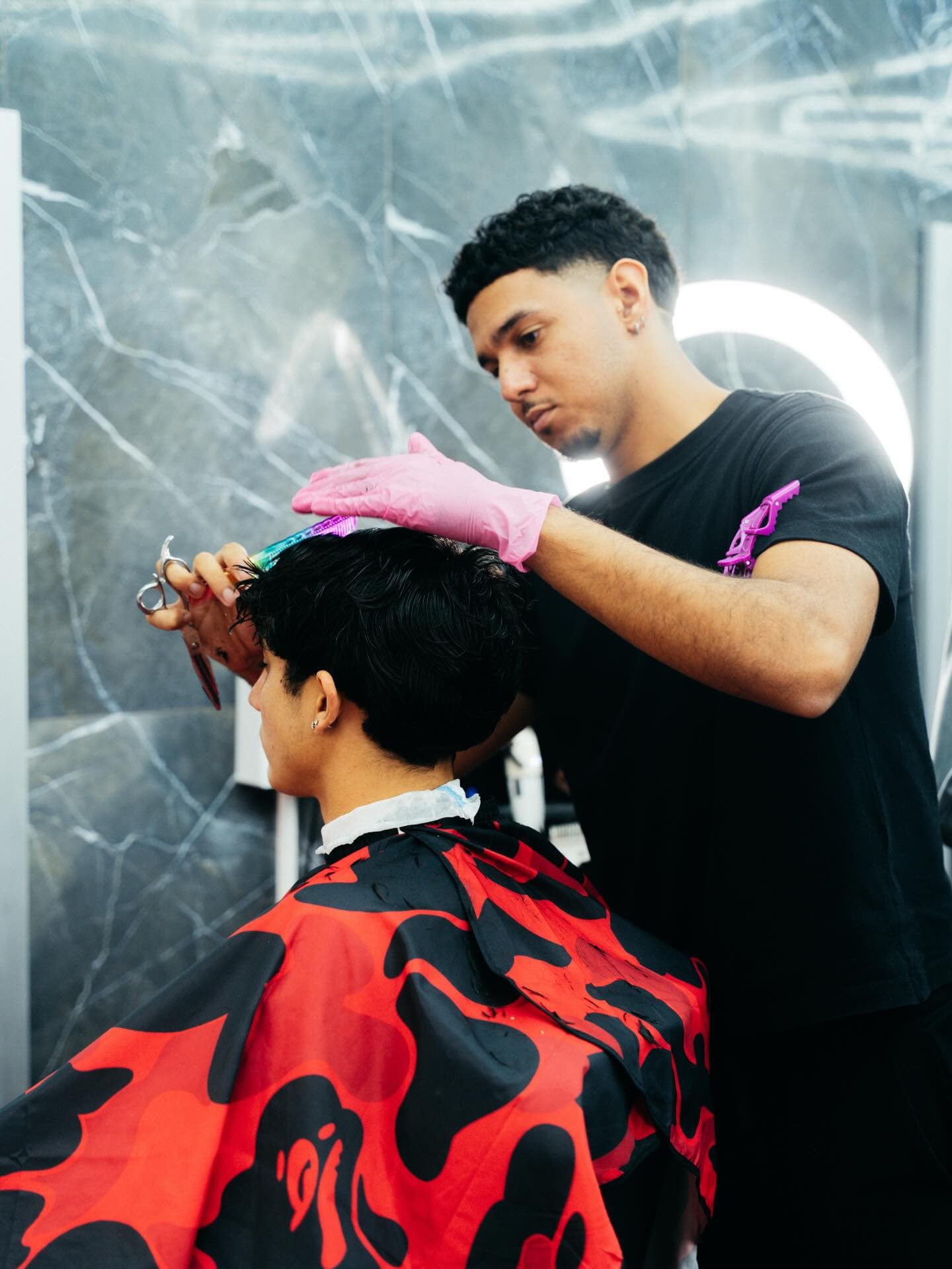 A team barber at work on a client's haircut at El Salon de la Fama